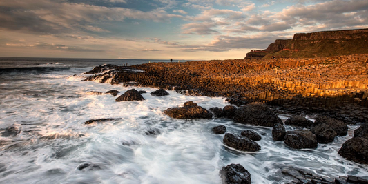 Image of the Giant's Causeway with waves crashing against the stone and rocks Tourism NI images used for Giant-Awakening-Tourism-NI-ASMR-Campaign-featuring-The-Sound-Healing-Spa